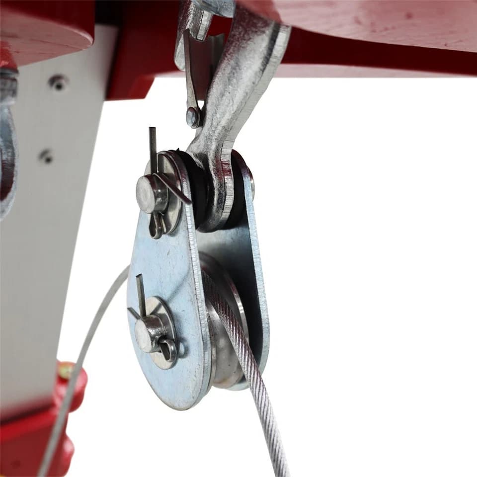 Close-up of the pulley assembly and wire rope beneath the tripod head
